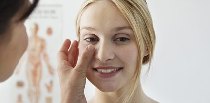 Lady getting the eye checked by a doctor