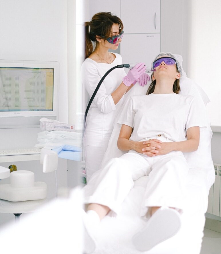 Doctor doing a laser treatment on the patient's face