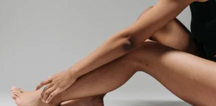Woman sittng highlighting her legs