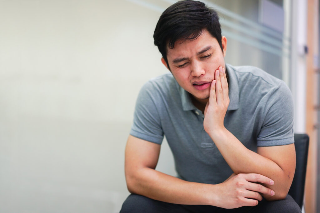 close up asian middle aged man feeling hurt from toothache symptom , unhealthy life concept