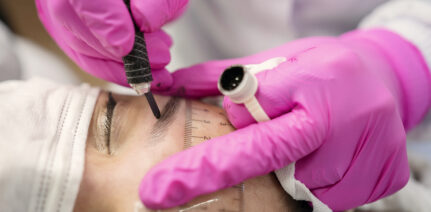 Beautician performing microblading technique in client eyebrow. Thread by thread micropigmentation
