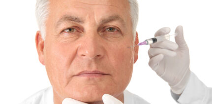 Older man receiving a filler treatment on the cheeks