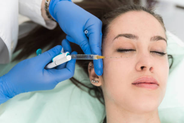 Closeup cropped image of female patient having procedure for lifting under eyes